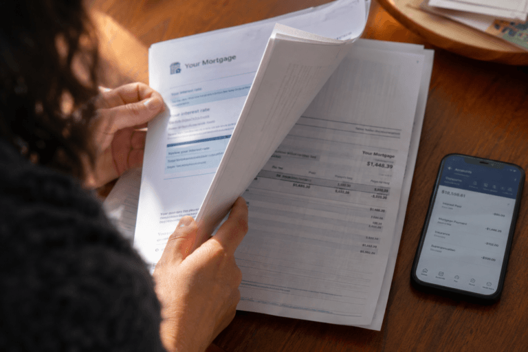 Person examing their mortgage statement and deciding on fixed vs variable rates